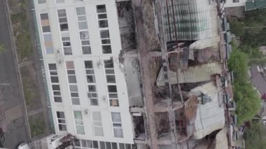 This stock vertical video shows a war-torn building in Stoyanka, Bucha district, Ukraine, flat, grey video