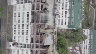 This stock vertical video shows a war-torn building in Stoyanka, Bucha district, Ukraine, flat, grey video