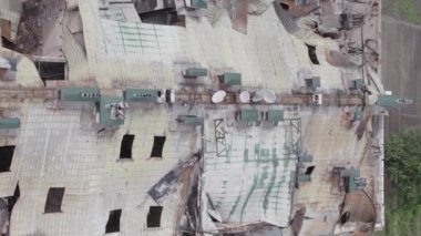 This stock vertical video shows a war-torn building in Stoyanka, Bucha district, Ukraine, flat, grey video