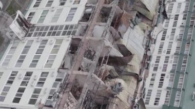 This stock vertical video shows a war-torn building in Stoyanka, Bucha district, Ukraine, flat, grey video