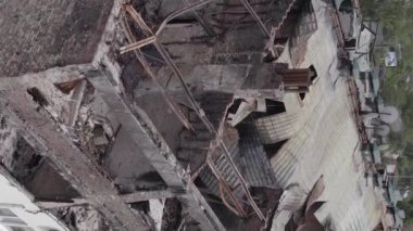 This stock vertical video shows a war-torn building in Stoyanka, Bucha district, Ukraine, flat, grey video