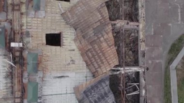 This stock vertical video shows a war-torn building in Stoyanka, Bucha district, Ukraine, flat, grey video