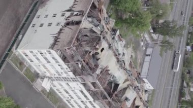 This stock vertical video shows a war-torn building in Stoyanka, Bucha district, Ukraine, flat, grey video