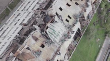 This stock vertical video shows a war-torn building in Stoyanka, Bucha district, Ukraine, flat, grey video