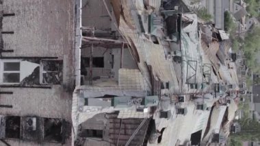 This stock vertical video shows a war-torn building in Stoyanka, Bucha district, Ukraine, flat, grey video