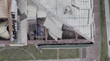 This stock vertical video shows a war-torn building in Stoyanka, Bucha district, Ukraine, flat, grey video