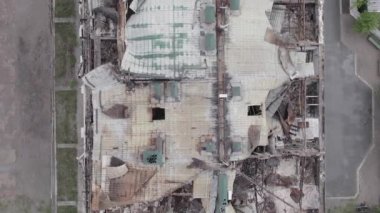 This stock vertical video shows a war-torn building in Stoyanka, Bucha district, Ukraine, flat, grey video