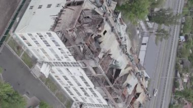 This stock vertical video shows a war-torn building in Stoyanka, Bucha district, Ukraine, flat, grey video