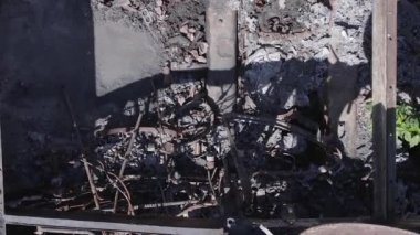 This stock vertical video shows an aerial view of destroyed military equipment in Ukraine, flat, grey video