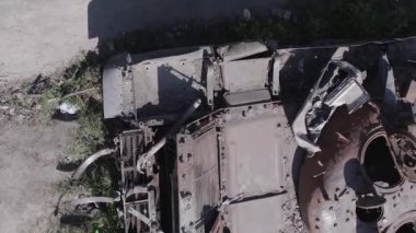 This stock vertical video shows an aerial view of destroyed military equipment in Ukraine, flat, grey video