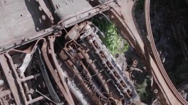 This stock vertical video shows an aerial view of destroyed military equipment in Ukraine, flat, grey video