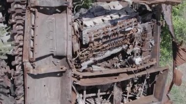 This stock vertical video shows an aerial view of destroyed military equipment in Ukraine, flat, grey video