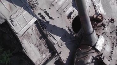 This stock vertical video shows an aerial view of destroyed military equipment in Ukraine, flat, grey video