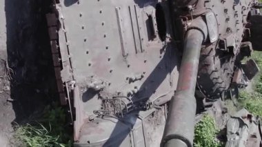This stock vertical video shows an aerial view of destroyed military equipment in Ukraine, flat, grey video