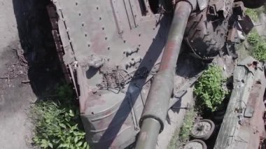 This stock vertical video shows an aerial view of destroyed military equipment in Ukraine, flat, grey video
