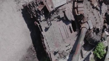 This stock vertical video shows an aerial view of destroyed military equipment in Ukraine, flat, grey video