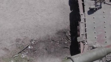 This stock vertical video shows an aerial view of destroyed military equipment in Ukraine, flat, grey video