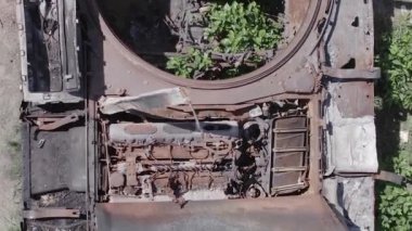 This stock vertical video shows an aerial view of destroyed military equipment in Ukraine, flat, grey video