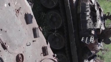 This stock vertical video shows an aerial view of destroyed military equipment in Ukraine, flat, grey video