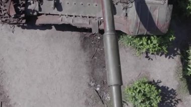 This stock vertical video shows an aerial view of destroyed military equipment in Ukraine, flat, grey video