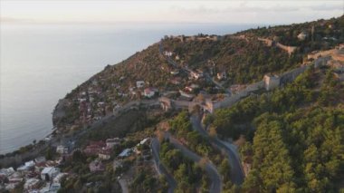 This stock footage shows aerial view of Alanya, Turkey - a resort town on the seashore in 8K resolution