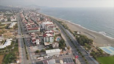 This stock footage shows aerial view of Alanya, Turkey - a resort town on the seashore in 8K resolution