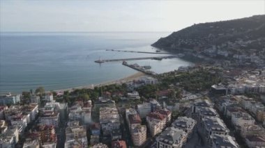 This stock footage shows aerial view of Alanya, Turkey - a resort town on the seashore in 8K resolution