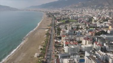 This stock footage shows aerial view of Alanya, Turkey - a resort town on the seashore in 8K resolution
