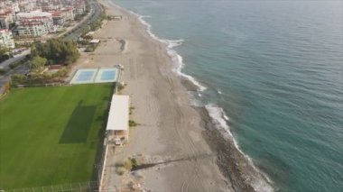 This stock footage shows aerial view of Alanya, Turkey - a resort town on the seashore in 8K resolution