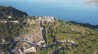 This stock footage shows aerial view of Alanya Castle, Alanya Kalesi in Turkey in 8K