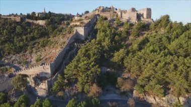 This stock footage shows aerial view of Alanya Castle, Alanya Kalesi in Turkey in 8K