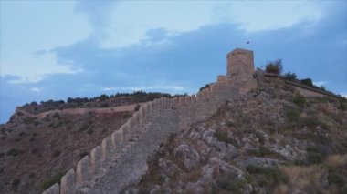 This stock footage shows aerial view of Alanya Castle, Alanya Kalesi in Turkey in 8K
