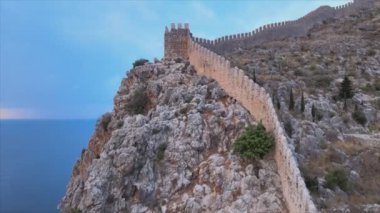 This stock footage shows aerial view of Alanya Castle, Alanya Kalesi in Turkey in 8K