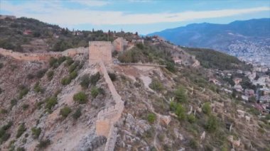 This stock footage shows aerial view of Alanya Castle, Alanya Kalesi in Turkey in 8K