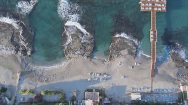 This stock footage shows aerial view of beach at the seaside resort town in Turkey in 8K resolution