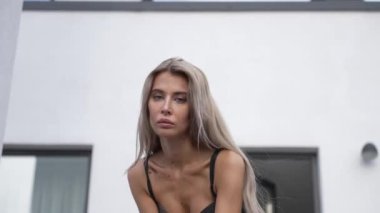 This stock video shows a beautiful girl in sexy erotic lingerie, slow motion