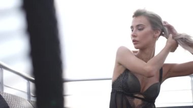This stock video shows a beautiful girl in sexy erotic lingerie, slow motion