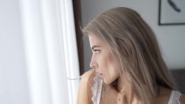 This stock video shows a beautiful girl in sexy erotic lingerie, slow motion