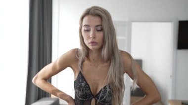 This stock video shows a beautiful girl in sexy erotic lingerie, slow motion