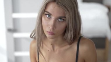 This stock video shows a beautiful girl in sexy erotic lingerie, slow motion