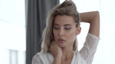 This stock video shows a beautiful girl in sexy erotic lingerie, slow motion