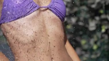 This stock slow motion video shows a sexy woman taking a shower