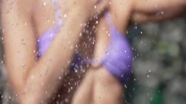 This stock slow motion video shows a sexy woman taking a shower