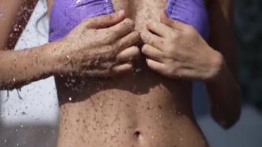 This stock slow motion video shows a sexy woman taking a shower