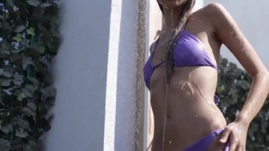 This stock slow motion video shows a sexy woman taking a shower