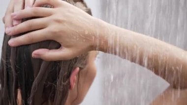 This stock slow motion video shows a sexy woman taking a shower