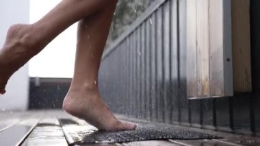 This stock slow motion video shows a sexy woman taking a shower