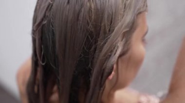 This stock slow motion video shows a sexy woman taking a shower