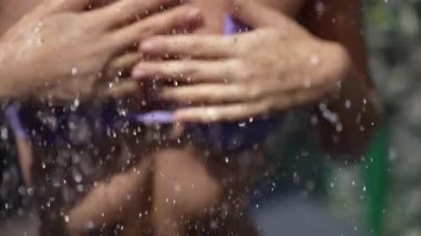 This stock slow motion video shows a sexy woman taking a shower