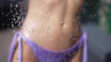 This stock slow motion video shows a sexy woman taking a shower